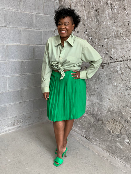 green pleated mini skirt